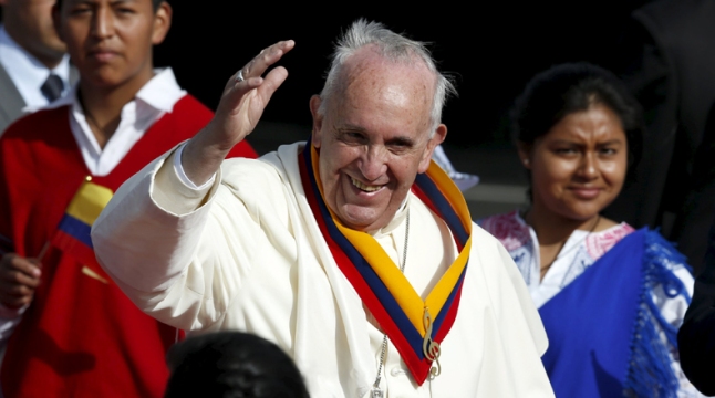 Pope Francis waves while wearing a neck sash in Ecuador's national colours after he landed in Quito, Ecuador, July 5, 2015. Pope Francis landed in Ecuador's capital Quito on Sunday to begin an eight-day tour of South America that will also include visits to Bolivia and Paraguay. On his first visit as pontiff to Spanish-speaking Latin America, the Argentina-born pope is scheduled to conduct masses in both Quito and the coastal city of Guayaquil before flying to Bolivia on Wednesday. REUTERS/Jose Miguel Gomez